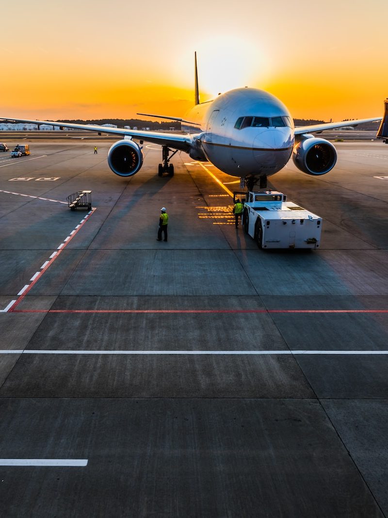 gray airplane on parking